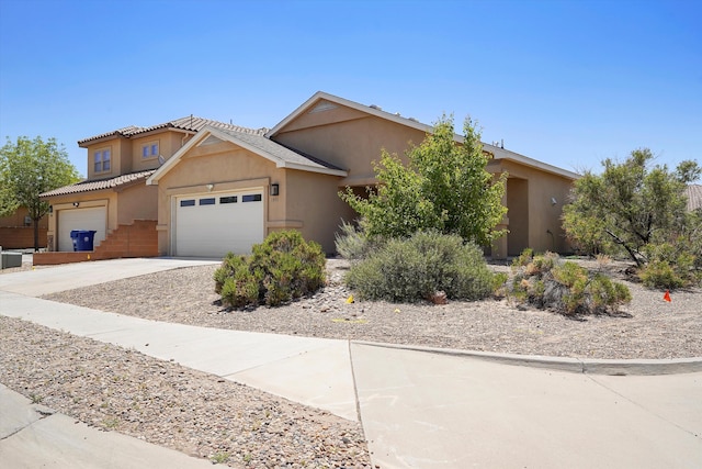 1951 Corta Rustica, Los Lunas, NM 87031 - view of front of home with driveway, stucco siding, and a garage