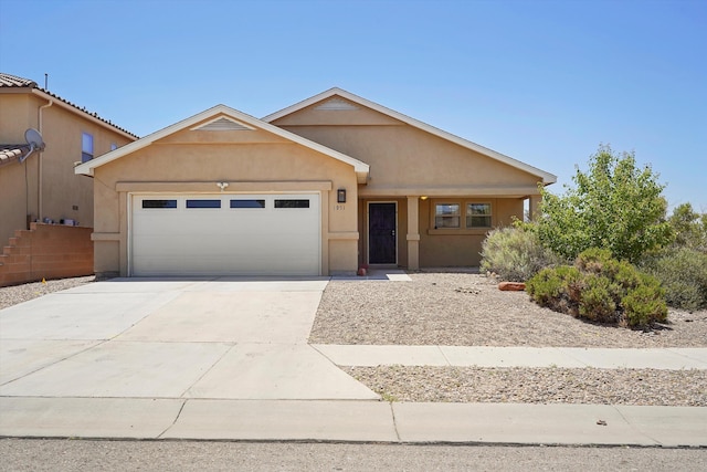 1951 Corta Rustica, Los Lunas, NM 87031 - view of front of property featuring a garage, stucco siding, and concrete driveway