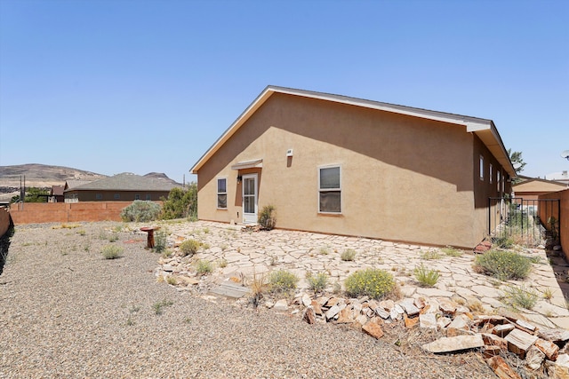 1951 Corta Rustica, Los Lunas, NM 87031 - back of house with stucco siding and a patio