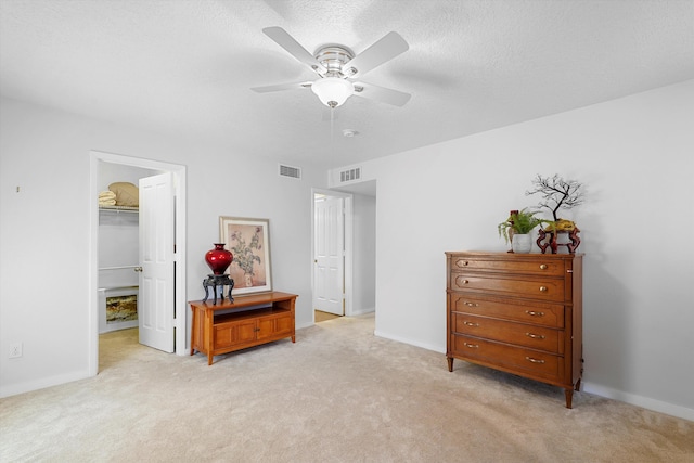 1951 Corta Rustica, Los Lunas, NM 87031 - bedroom with light colored carpet, a walk in closet, ceiling fan, and a textured ceiling