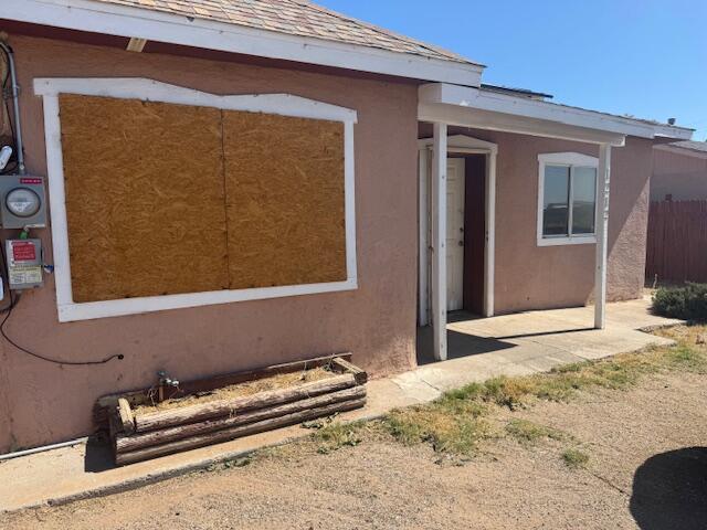 1212 W Reinken Ave, Belen, NM 87002 - rear view of house featuring stucco siding