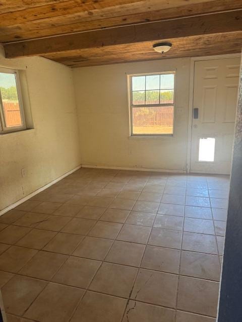 1212 W Reinken Ave, Belen, NM 87002 - spare room with plenty of natural light, light tile patterned floors, and beam ceiling