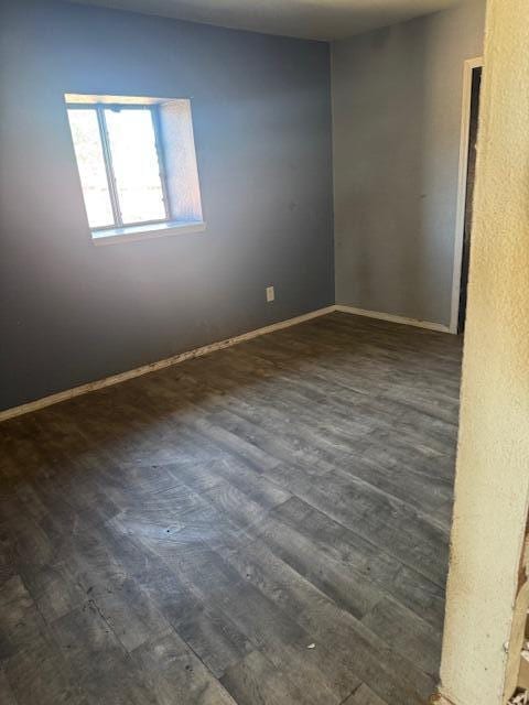 1212 W Reinken Ave, Belen, NM 87002 - spare room with dark wood-type flooring and baseboards