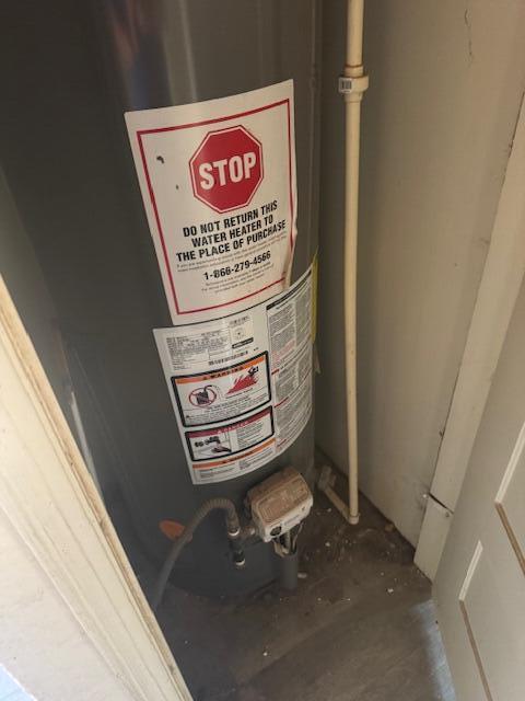 1212 W Reinken Ave, Belen, NM 87002 - utility room with water heater