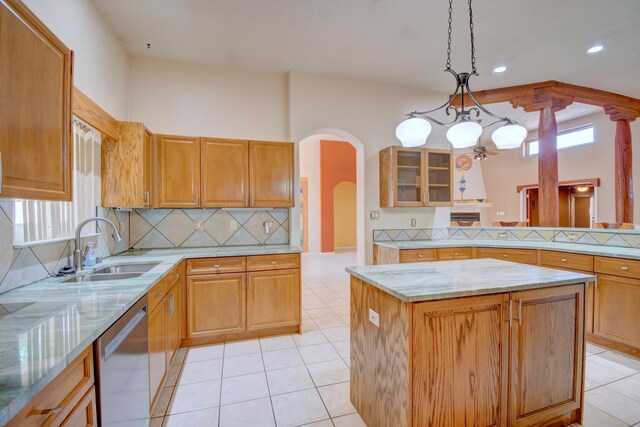 2705 Pueblo Grande Trl NW, Albuquerque, NM 87120 - kitchen featuring dishwasher, a sink, arched walkways, backsplash, and light stone countertops