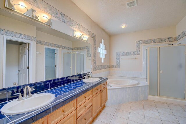 2705 Pueblo Grande Trl NW, Albuquerque, NM 87120 - bathroom with a stall shower, a bath, double vanity, and tile patterned floors