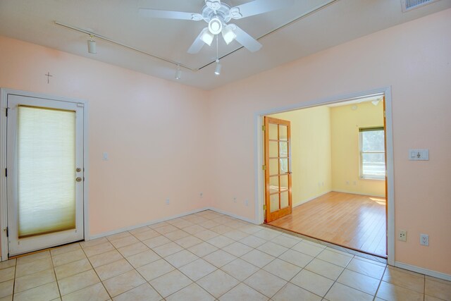 2705 Pueblo Grande Trl NW, Albuquerque, NM 87120 - spare room featuring a ceiling fan, rail lighting, light tile patterned floors, and baseboards