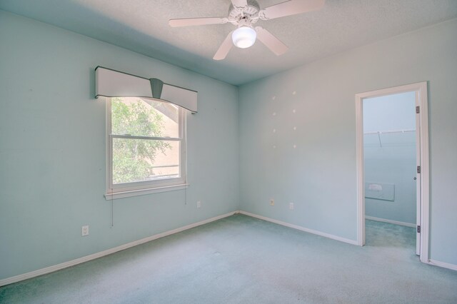2705 Pueblo Grande Trl NW, Albuquerque, NM 87120 - carpeted empty room with baseboards, a textured ceiling, and a ceiling fan