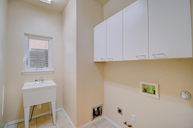 2705 Pueblo Grande Trl NW, Albuquerque, NM 87120 - washroom with electric dryer hookup, washer hookup, cabinet space, baseboards, and light tile patterned floors