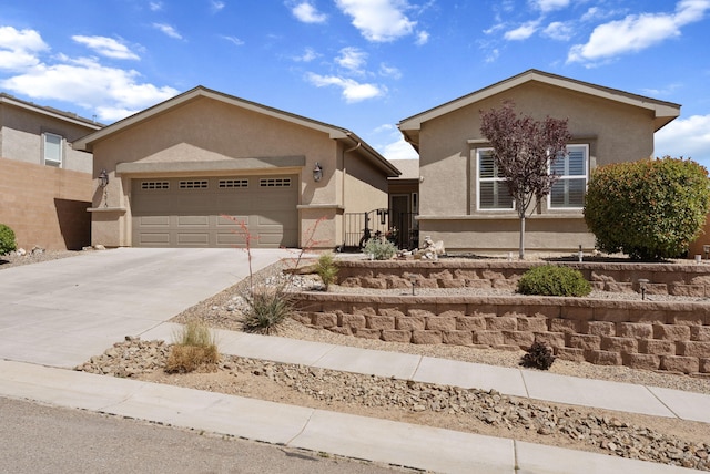 4210 Agave Ct SW, Los Lunas, NM 87031 - view of front of home with stucco siding, an attached garage, and driveway