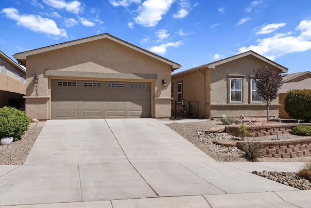 4210 Agave Ct SW, Los Lunas, NM 87031 - ranch-style house with stucco siding, concrete driveway, and a garage