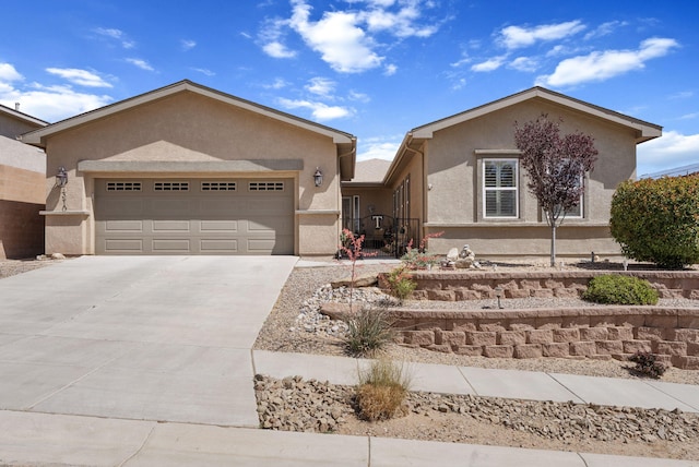 4210 Agave Ct SW, Los Lunas, NM 87031 - ranch-style house with stucco siding, a garage, and concrete driveway