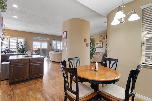 4210 Agave Ct SW, Los Lunas, NM 87031 - dining space with a chandelier, light wood finished floors, recessed lighting, a textured ceiling, and baseboards