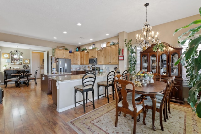 4210 Agave Ct SW, Los Lunas, NM 87031 - dining room featuring a chandelier, light wood-type flooring, and recessed lighting