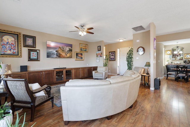 4210 Agave Ct SW, Los Lunas, NM 87031 - living room with ceiling fan, wood finished floors, a chandelier, and baseboards