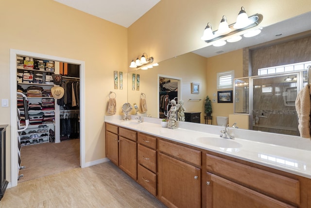 4210 Agave Ct SW, Los Lunas, NM 87031 - bathroom with double vanity, a walk in closet, a stall shower, and toilet