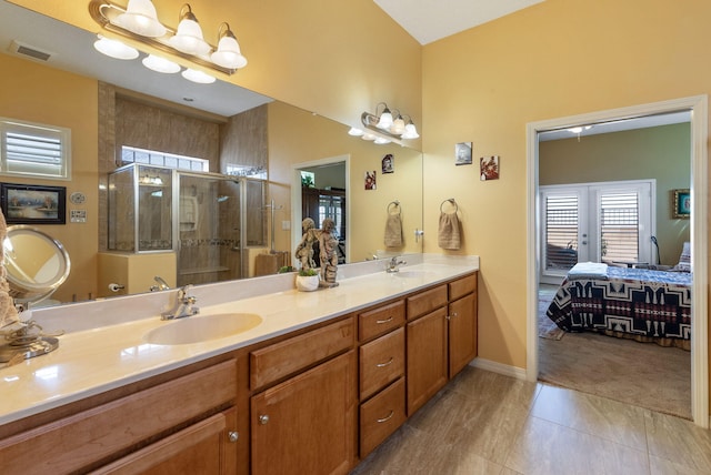 4210 Agave Ct SW, Los Lunas, NM 87031 - full bathroom with connected bathroom, double vanity, a stall shower, tile patterned flooring, and french doors