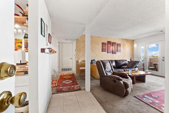 3867 Montgomery Blvd NE Unit 1633, Albuquerque, NM 87109 - carpeted living room featuring a textured ceiling, tile patterned floors, french doors, and wallpapered walls