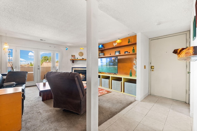 3867 Montgomery Blvd NE Unit 1633, Albuquerque, NM 87109 - tiled living area featuring a textured ceiling, french doors, carpet, and a warm lit fireplace
