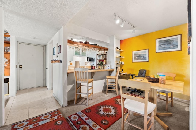 3867 Montgomery Blvd NE Unit 1633, Albuquerque, NM 87109 - home office with track lighting, a textured ceiling, light tile patterned floors, and baseboards