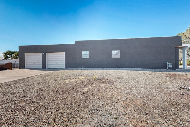 648 Frederico Blvd, Rio Communities, NM 87002 - view of front of home with stucco siding, driveway, and a garage