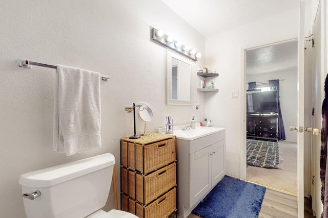 648 Frederico Blvd, Rio Communities, NM 87002 - bathroom with toilet, vanity, and wood finished floors