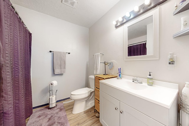 648 Frederico Blvd, Rio Communities, NM 87002 - bathroom featuring wood finished floors, vanity, and toilet
