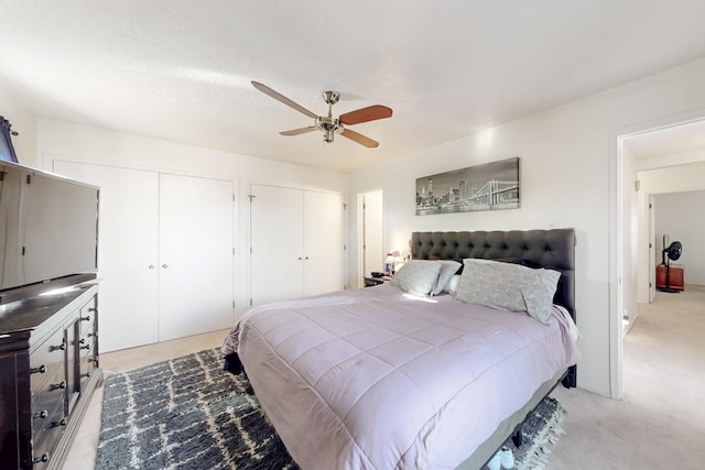 648 Frederico Blvd, Rio Communities, NM 87002 - bedroom featuring multiple closets, light carpet, and ceiling fan