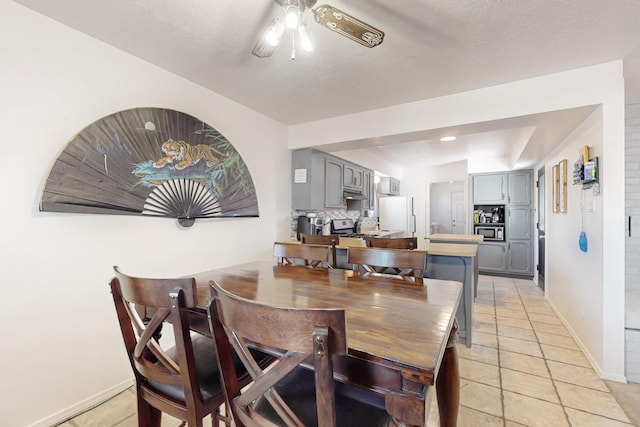 648 Frederico Blvd, Rio Communities, NM 87002 - dining area with light tile patterned floors, a ceiling fan, and baseboards