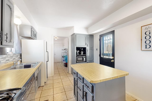 648 Frederico Blvd, Rio Communities, NM 87002 - kitchen with gray cabinetry, appliances with stainless steel finishes, a sink, backsplash, and light tile patterned floors