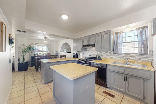 648 Frederico Blvd, Rio Communities, NM 87002 - kitchen featuring stainless steel range with gas stovetop, dishwasher, a sink, a peninsula, and gray cabinetry