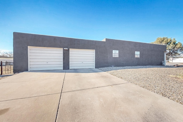 648 Frederico Blvd, Rio Communities, NM 87002 - pueblo revival-style home featuring driveway, stucco siding, and a garage