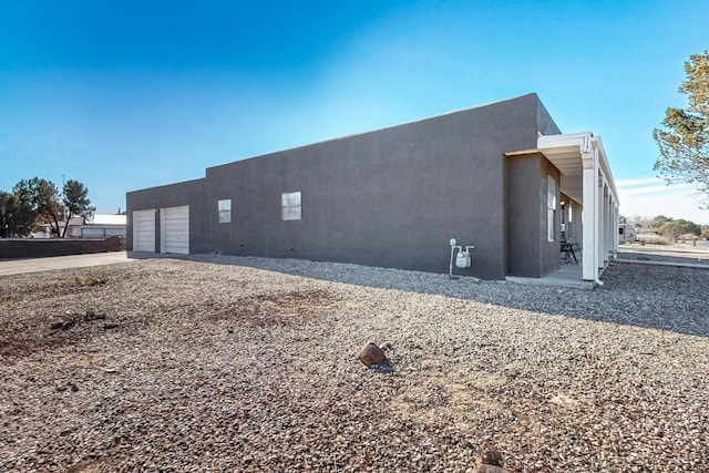 648 Frederico Blvd, Rio Communities, NM 87002 - view of property exterior featuring stucco siding, a garage, and driveway