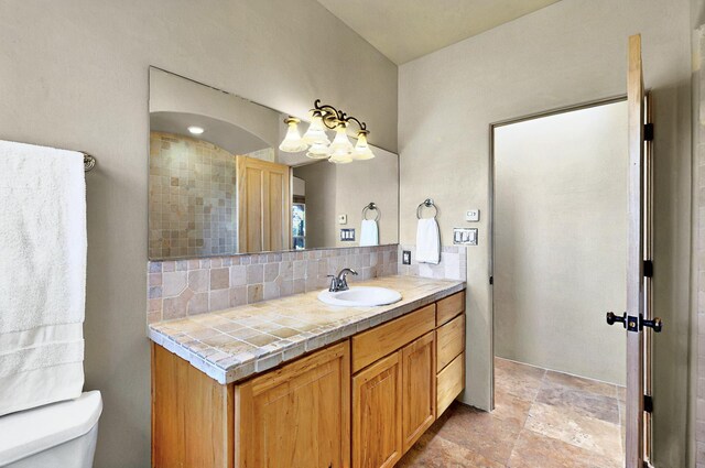 1 Seasons Cir, Placitas, NM 87043 - full bath with vanity, decorative backsplash, toilet, and stone finish floors