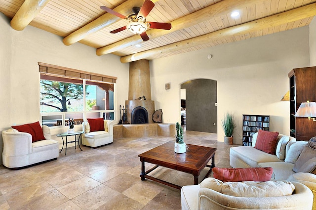 1 Seasons Cir, Placitas, NM 87043 - living area featuring wooden ceiling with exposed beams, arched walkways, ceiling fan, and stone tile flooring