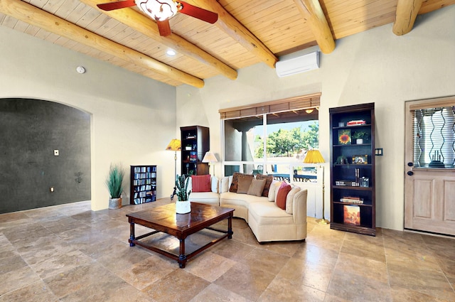 1 Seasons Cir, Placitas, NM 87043 - living room featuring wooden ceiling with exposed beams, arched walkways, a wall mounted AC, ceiling fan, and stone tile flooring