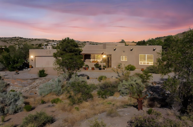 1 Seasons Cir, Placitas, NM 87043 - southwest-style home featuring stucco siding, driveway, and a garage