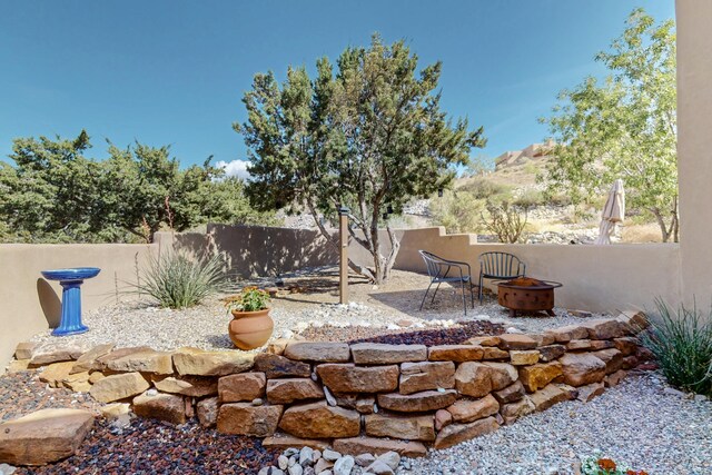 1 Seasons Cir, Placitas, NM 87043 - fenced backyard featuring a fire pit and a patio