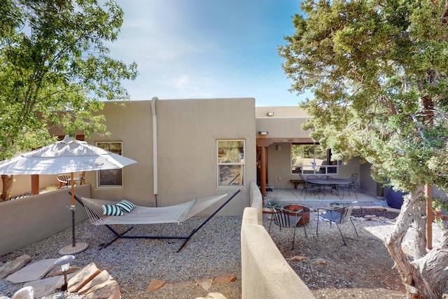 1 Seasons Cir, Placitas, NM 87043 - back of house with stucco siding and a patio