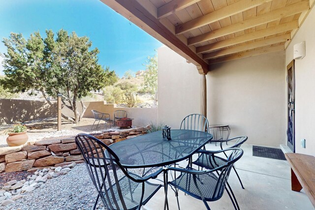 1 Seasons Cir, Placitas, NM 87043 - fenced backyard with a patio area, outdoor dining area, and a fire pit