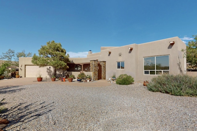 1 Seasons Cir, Placitas, NM 87043 - southwest-style home with an attached garage, driveway, and stucco siding