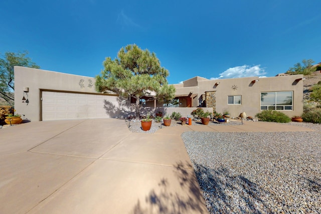 1 Seasons Cir, Placitas, NM 87043 - southwest-style home with stucco siding, a garage, and concrete driveway