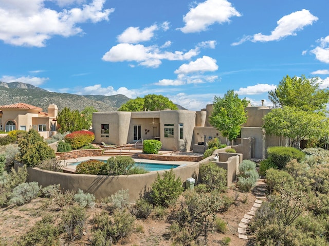 1572 Eagle Ridge Ct NE, Albuquerque, NM 87122 - rear view of property with a mountain view and stucco siding