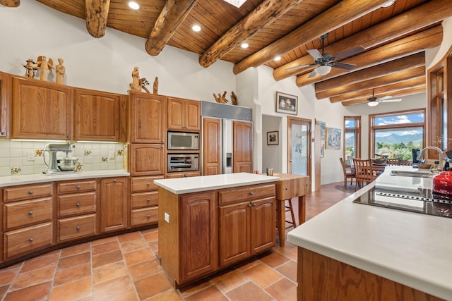 1572 Eagle Ridge Ct NE, Albuquerque, NM 87122 - kitchen with built in appliances, wood ceiling with exposed beams, a sink, a center island, and brown cabinets