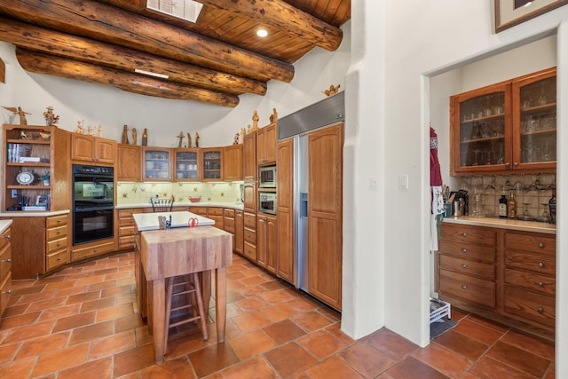 1572 Eagle Ridge Ct NE, Albuquerque, NM 87122 - kitchen with built in appliances, light countertops, backsplash, wood ceiling with exposed beams, and a kitchen island