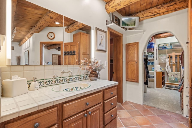 1572 Eagle Ridge Ct NE, Albuquerque, NM 87122 - bathroom with wood ceiling with exposed beams, vanity, decorative backsplash, and tile patterned flooring