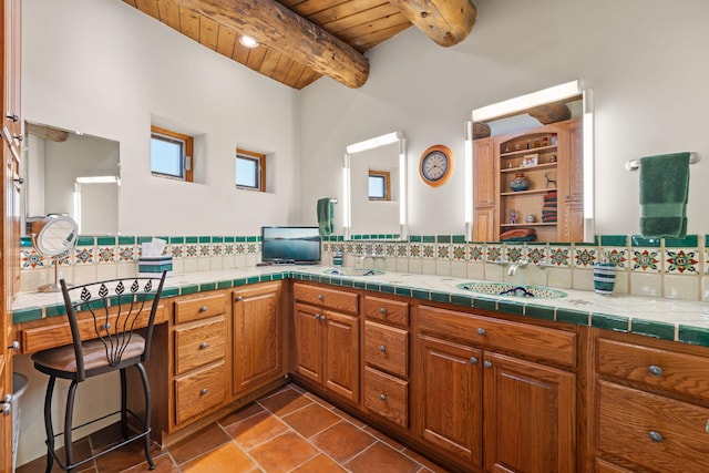 1572 Eagle Ridge Ct NE, Albuquerque, NM 87122 - bathroom featuring wood ceiling with exposed beams, decorative backsplash, double vanity, and tile patterned flooring