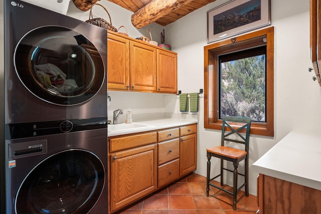1572 Eagle Ridge Ct NE, Albuquerque, NM 87122 - laundry room featuring stacked washing machine and dryer, cabinet space, wood ceiling, and tile patterned floors