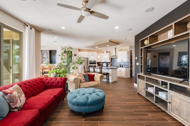 1608 Mammoth Way, Albuquerque, NM 87120 - living area featuring a textured ceiling, a ceiling fan, dark wood finished floors, and recessed lighting