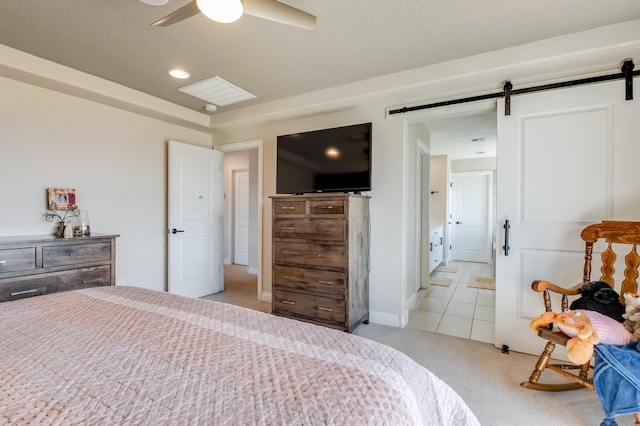 1608 Mammoth Way, Albuquerque, NM 87120 - bedroom with a barn door, light colored carpet, a ceiling fan, and light tile patterned floors